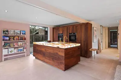 a large kitchen with a large wooden island with a sink at Magical Woods in Bergen