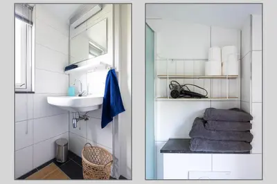 a bathroom with a sink and a mirror and towels at Studio Hooischuur Alkmaar/Bergen in Alkmaar