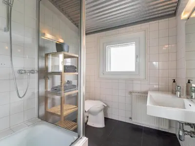 a bathroom with a shower and a toilet and a sink at Beachhouse II in Bergen aan Zee