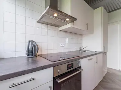 a kitchen with a sink and a stove at Beachhouse II in Bergen aan Zee