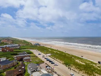 an aerial view of a beach with cars parked at Beachhouse II in Bergen aan Zee