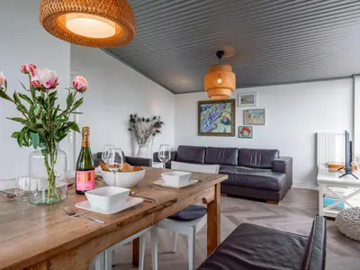 a living room with a table with wine glasses and a couch at Beachhouse II in Bergen aan Zee