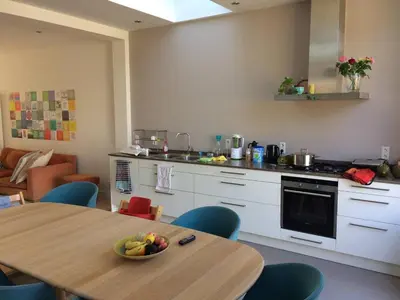 a kitchen with a table with a bowl of fruit on it at just like home in Haarlem