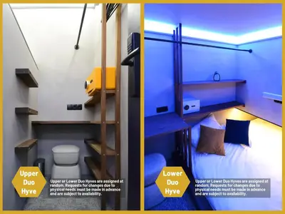 a small room with a bed and a toilet at The Hyve Capsule hostel Amsterdam in Amsterdam