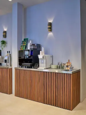 a kitchen with a counter with a coffee maker at The Hyve Capsule hostel Amsterdam in Amsterdam