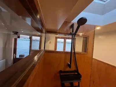 a bowling lane in a room with a view of the water at Casey's Lake View House Boat in Amsterdam