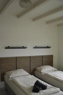 two twin beds in a room with at Cozy bungalow (Near beach, tulip fields, etc) in Noordwijkerhout