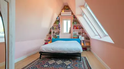 a bedroom with a bed and a book shelf at Villa Boutique in Bergen