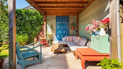 a patio with a couch and a table and chairs at Villa Boutique in Bergen