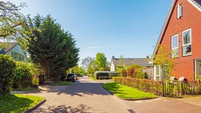 a residential street with houses and a driveway at Villa Boutique in Bergen