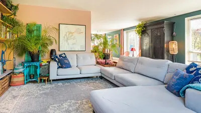 a living room with two couches and blue walls at Villa Boutique in Bergen