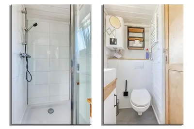 a bathroom with a shower and a toilet at Rode Tiny House met zwembad in Zeewolde