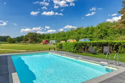a swimming pool in the backyard of a home at Forest Villa with shared pool & Eco Wellness in Zeewolde