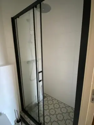 a shower with a glass door in a bathroom at Gorgeous room near Haarlem Station, city center in Haarlem