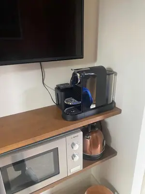 a microwave and a coffee maker on a shelf at Gorgeous room near Haarlem Station, city center in Haarlem