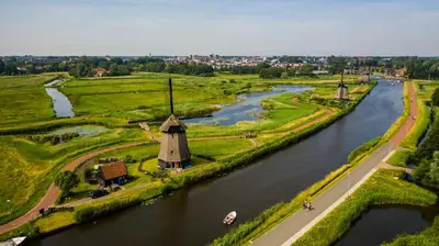 an aerial view of a river with a windmill at Villa View in Alkmaar