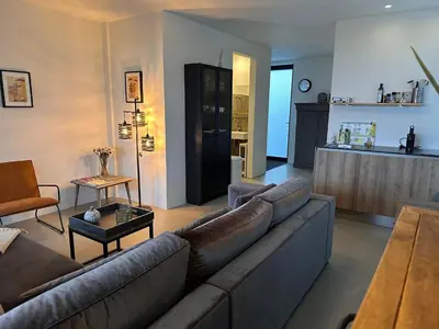 a living room with a couch and a kitchen at Villa View in Alkmaar