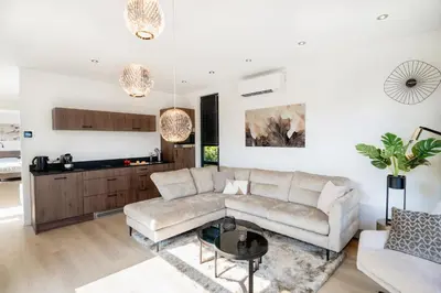 a living room with a couch and a table at MarinaPark Residentie Bloemendaal in Vogelenzang