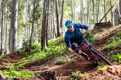 a man riding a bike on a dirt trail at Kust Geluk in Schoorl