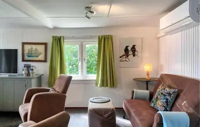 a living room with a couch and chairs and a window at Stunning Stacaravan In Reeuwijk in Reeuwijk