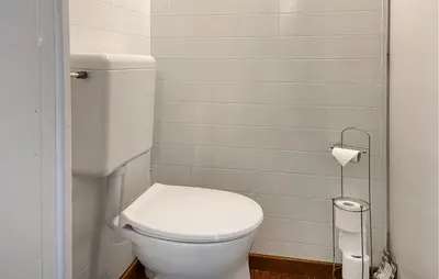 a bathroom with a white toilet and a roll of toilet paper at Stunning Stacaravan In Reeuwijk in Reeuwijk