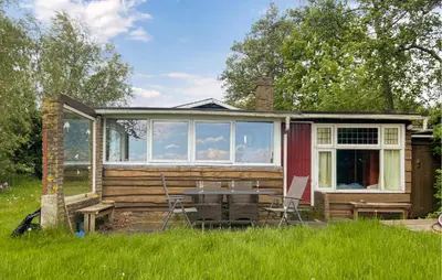 a tiny house with a table and chairs in the yard at Stunning Stacaravan In Reeuwijk in Reeuwijk