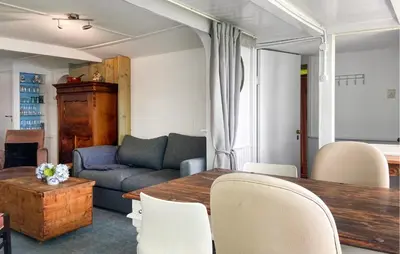 a living room with a table and a couch at Stunning Stacaravan In Reeuwijk in Reeuwijk