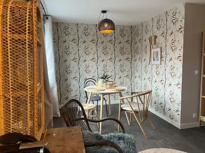 a dining room with a table and chairs and a wall at Mint aan het strand in Egmond aan Zee