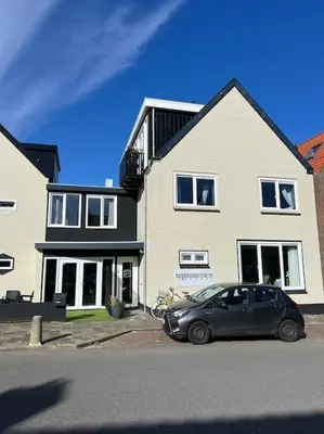 a car parked in front of a house at Mint aan het strand in Egmond aan Zee