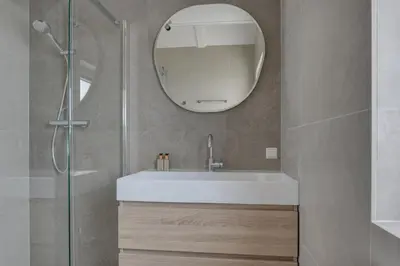 a bathroom with a white sink and a mirror at Meerzicht 57 - 3 bedroom appt with sunny terrace in Uitgeest