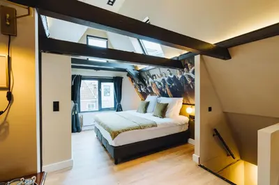 a bedroom with a large bed in a room at Løk Historics luxury art-inspired loft in historic city centre! in Haarlem
