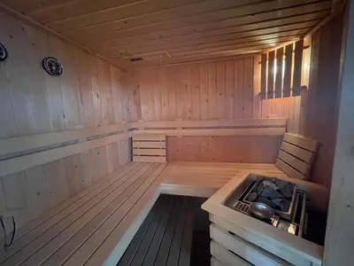 an inside of a sauna with a stove in it at Poellodge XL, houseboat met whirlpool en sauna in Aalsmeer
