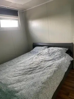 a bed in a bedroom with a window at Nieuwendijk hoeve in Oud-Ade