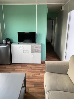 a living room with a couch and a flat screen tv at Nieuwendijk hoeve in Oud-Ade