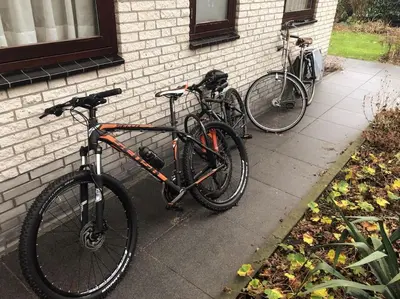two bikes are parked next to a brick building at Enjoyable holiday home in Noordwijk