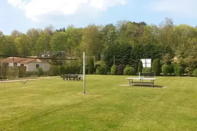a park with two picnic tables and a basketball hoop at Enjoyable holiday home in Noordwijk