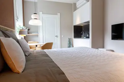 a bedroom with a large bed with white sheets and pillows at Boutique Pastorale in Linschoten