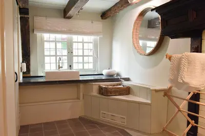 a kitchen with a sink and a window at Huis met de Kogel in Alkmaar