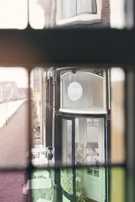 a view of a building through a window at Huis met de Kogel in Alkmaar