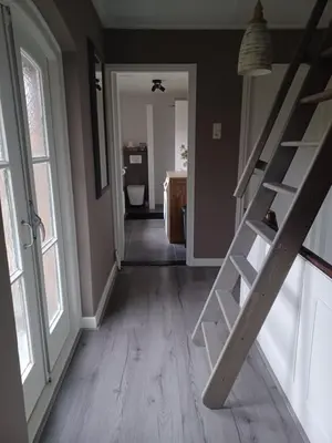 a hallway with a staircase in a house at Gastenverblijf in het voorhuis van onze woonboerderij in Maartensdijk