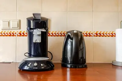 a coffee maker sitting on a counter next to a coffee pot at Gastenverblijf in het voorhuis van onze woonboerderij in Maartensdijk