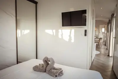 a towel animal sitting on a bed in a bedroom at Waterfront tiny home with spacious garden in Vinkeveen