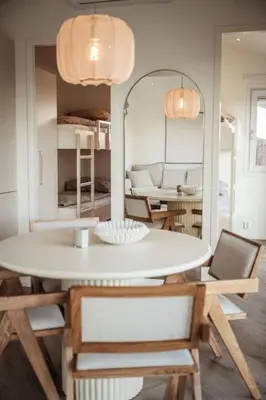 a dining room with a white table and chairs at Waterfront tiny home with spacious garden in Vinkeveen