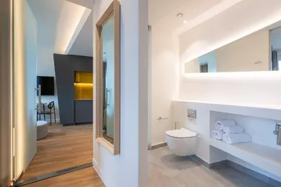 a bathroom with a toilet and a mirror at Limehome Amsterdam Gatwickstraat in Amsterdam