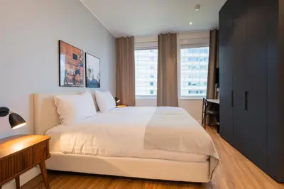 a bedroom with a large bed and a desk at Limehome Amsterdam Gatwickstraat in Amsterdam