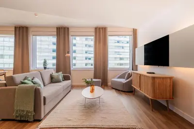a living room with a couch and a tv at Limehome Amsterdam Gatwickstraat in Amsterdam