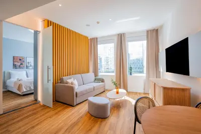 a living room with a couch and a table at Limehome Amsterdam Gatwickstraat in Amsterdam