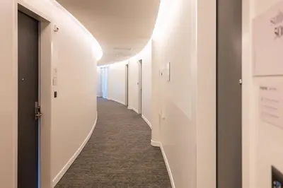 a corridor in a hospital with white walls and a corridorngthngthngthngthngth at Limehome Amsterdam Gatwickstraat in Amsterdam