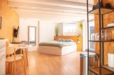 a bedroom with a bed and a table and chairs at Beach House Sea La Vie 50 meters from the beach in Zandvoort