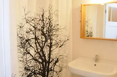 a bathroom with a tree stenciled on the wall at Beach House Sea La Vie 50 meters from the beach in Zandvoort